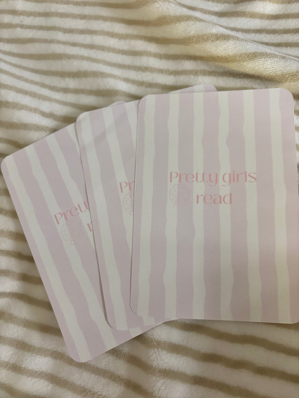 Kindle basic inserts, pink and white stripes with text.